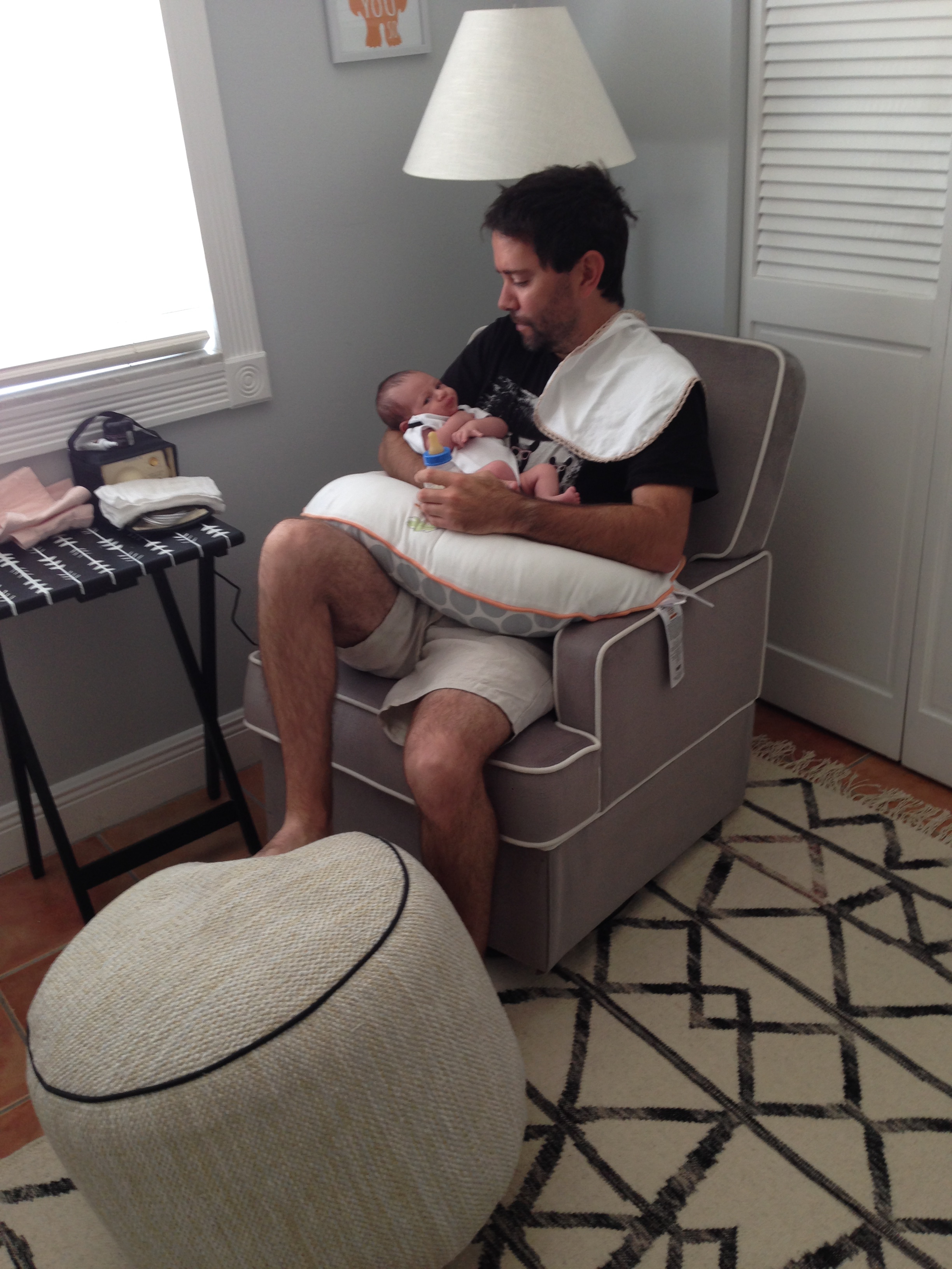 FF feeding Alfie on our glider. Ottoman from Target. Rug from West Elm. Folding table with Medela Breastpump.